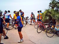56bikepath05  Riders gather around Larrys new sleek ultra-lite white Pinarello. One sleek fast ride there!